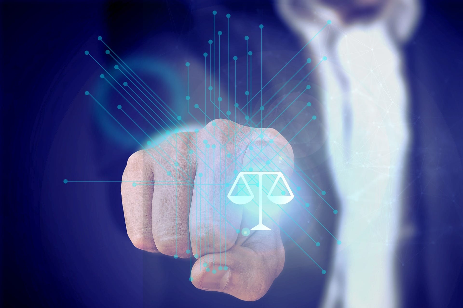 A hand points at a digital scale icon, symbolizing justice and law, with abstract lines and blue light emanating from the gesture.